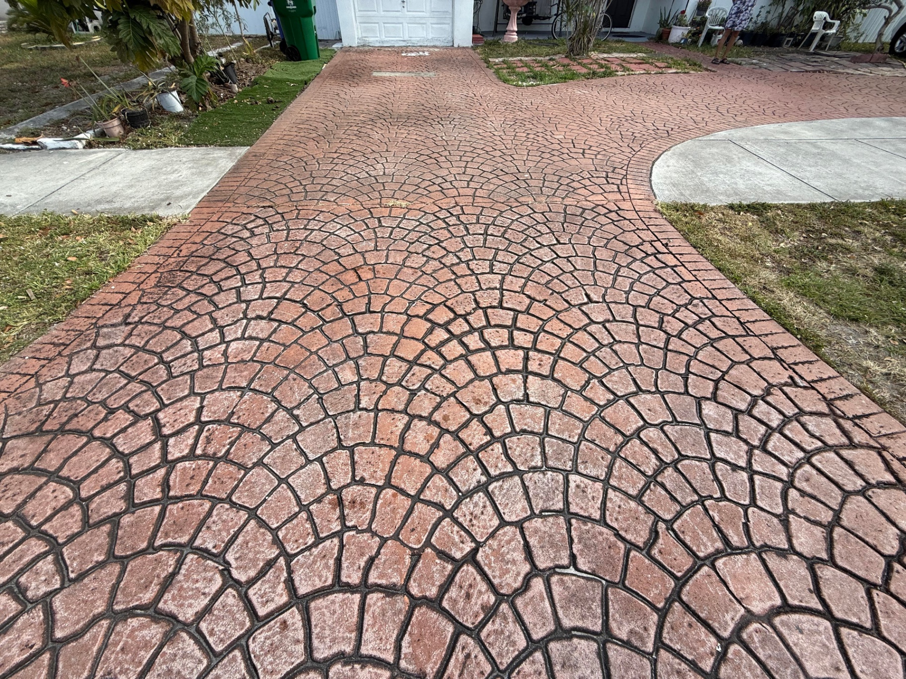 Stamped concrete driveway sealed by Patty's Sealing — before